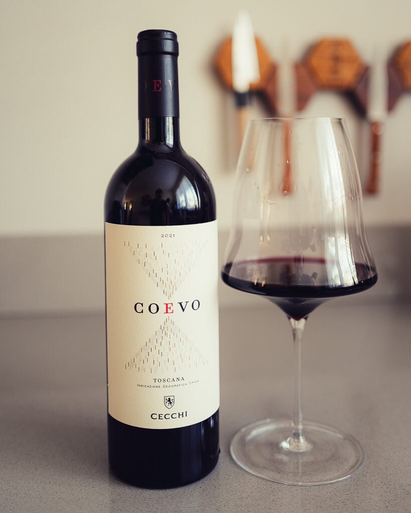 Cecchi Coevo 2021 Toscana red wine bottle next to a glass of red wine