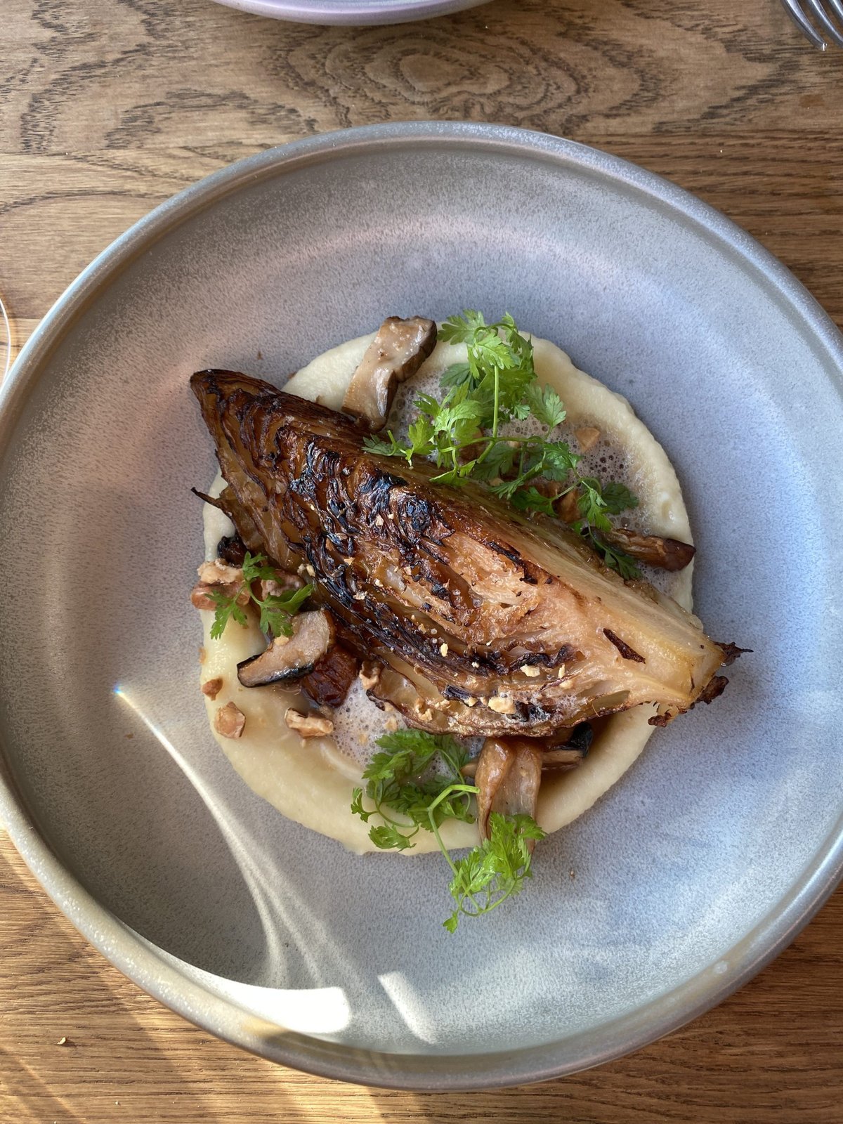 Bord met geroosterde witlof op puree met paddenstoelen en kruiden
