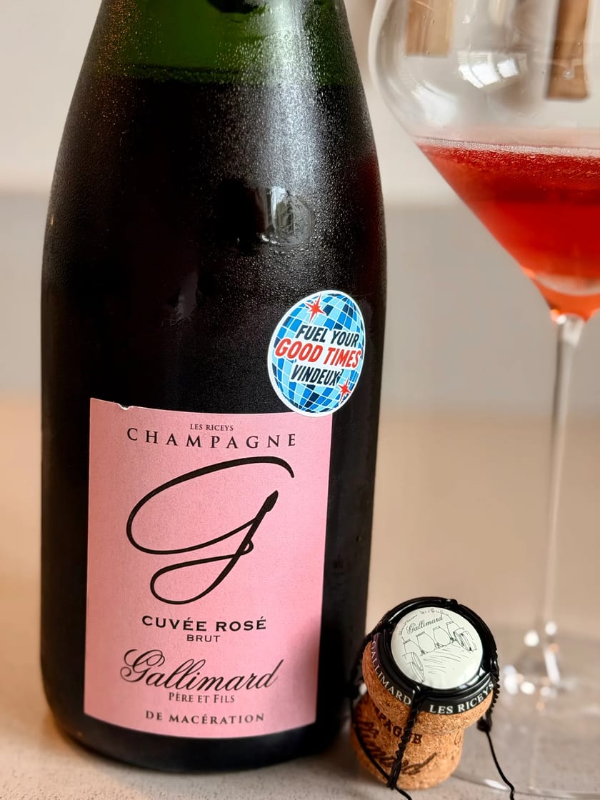 Fles Champagne Gallimard Cuvée Rosé uit Les Riceys met Vindeux-sticker naast een glas diep roodroze champagne